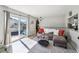 Inviting living room features a sliding glass door with a small balcony, creating a sunny space at 1225 S Oneida St # 248, Denver, CO 80224