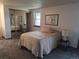 Cozy bedroom with mirrored closet doors and neutral decor at 7505 W Yale St # 2103, Denver, CO 80227