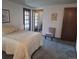 Spacious bedroom with carpeted floor, large windows, and access to a bathroom at 7505 W Yale St # 2103, Denver, CO 80227