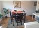Dining area with a square table, four chairs, and hardwood floors at 7505 W Yale St # 2103, Denver, CO 80227