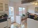 Bright kitchen with white cabinets, stainless steel appliances, and access to a patio at 7505 W Yale St # 2103, Denver, CO 80227