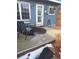 Small patio with seating area, and partial snow and ice coverage at 7505 W Yale St # 2103, Denver, CO 80227