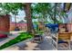 Relaxing patio with seating area, mature tree, and string lights at 1563 High St, Denver, CO 80218