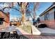 Large backyard with patio, mature tree, and a mountain mural at 1563 High St, Denver, CO 80218
