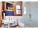 Updated bathroom with pedestal sink, toilet, and a large glass-enclosed shower at 1563 High St, Denver, CO 80218
