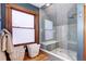 Modern bathroom with a glass shower, gray tile, and built-in seat at 1563 High St, Denver, CO 80218