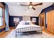 Large bedroom with king bed, hardwood floors, and exposed brick wall at 1563 High St, Denver, CO 80218
