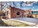 Detached brick garage with a large concrete parking area at 1563 High St, Denver, CO 80218