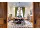 Bright dining room with a round wooden table and seating for six, complemented by an ornate rug at 1563 High St, Denver, CO 80218