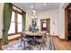 Elegant dining room, hardwood floors, large windows with green curtains, and a beautiful chandelier at 1563 High St, Denver, CO 80218