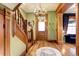 Grand entry with wood staircase, hardwood floors, and a chandelier at 1563 High St, Denver, CO 80218