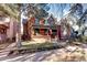 Brick two-story home with a classic design, front porch, and landscaped yard at 1563 High St, Denver, CO 80218