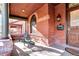 Inviting front porch with brick columns and a wooden door at 1563 High St, Denver, CO 80218