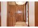 Long hallway with rich wood-paneled walls and doors at 1563 High St, Denver, CO 80218