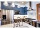Modern kitchen with stainless steel appliances, white quartz countertops and a stylish blue cabinetry at 1563 High St, Denver, CO 80218