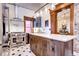 Updated kitchen with stainless steel appliances and a large island, tin ceiling, and hardwood floors at 1563 High St, Denver, CO 80218