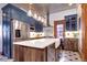 Renovated kitchen, stainless steel appliances, white quartz countertops, and a farmhouse sink at 1563 High St, Denver, CO 80218