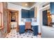 Laundry room with blue cabinets, a built-in workspace and a washer and dryer at 1563 High St, Denver, CO 80218