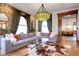Living room with sectional sofa, hardwood floors, and a stained glass light at 1563 High St, Denver, CO 80218