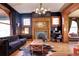 Spacious living room with dark walls, hardwood floors, and a fireplace at 1563 High St, Denver, CO 80218