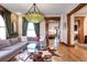 Spacious living area with hardwood floors, and a view into the kitchen at 1563 High St, Denver, CO 80218