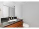 Convenient half bathroom featuring a modern vanity with granite countertop at 2366 S Troy St, Aurora, CO 80014