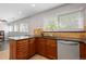 Eat-in kitchen featuring warm wood cabinetry, granite counters, and ample natural light at 2366 S Troy St, Aurora, CO 80014