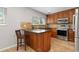 Well-appointed kitchen with wood cabinets, stainless appliances, and tile backsplash at 2366 S Troy St, Aurora, CO 80014