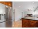 Bright kitchen with stainless steel refrigerator, wood cabinetry, and tile flooring at 2366 S Troy St, Aurora, CO 80014