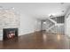 Bright living room with fireplace, wood floors, and staircase leading to the upper level at 2366 S Troy St, Aurora, CO 80014