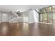 Open living room with wood floors and lots of light coming from the atrium at 2366 S Troy St, Aurora, CO 80014