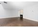 Open-concept living room with wood floors and brick fireplace at 2366 S Troy St, Aurora, CO 80014