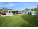 Aerial view of a landscaped backyard with artificial turf, seating, and a covered patio at 1892 S Meade St, Denver, CO 80219