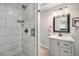 Modern bathroom with a glass-enclosed shower and updated vanity with white countertop at 1892 S Meade St, Denver, CO 80219