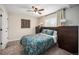 Comfortable bedroom featuring a ceiling fan, and two dark dressers providing ample storage space at 1892 S Meade St, Denver, CO 80219