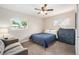 Cozy bedroom featuring a ceiling fan, two windows, and a comfy armchair at 1892 S Meade St, Denver, CO 80219
