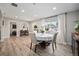 Cozy dining area with round table and chairs with vinyl floors and a large window bringing in natural light at 1892 S Meade St, Denver, CO 80219