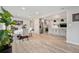 Open concept space with a dining area next to a modern kitchen featuring wood-look vinyl flooring at 1892 S Meade St, Denver, CO 80219