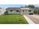 Inviting single-story home with a well-manicured lawn and a charming orange front door entrance at 1892 S Meade St, Denver, CO 80219