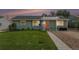 Charming single-story home featuring a well-maintained lawn and an inviting orange front door at 1892 S Meade St, Denver, CO 80219