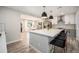 Spacious kitchen boasting a large island with seating and stainless steel appliances with herringbone backsplash at 1892 S Meade St, Denver, CO 80219