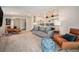 Cozy living room with carpet, neutral couch, and plenty of seating for entertaining guests at 1892 S Meade St, Denver, CO 80219
