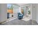 Bright sun room with large windows and a view of the backyard and detached garage at 1892 S Meade St, Denver, CO 80219