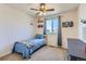 Charming bedroom featuring a plush bed, ceiling fan and natural light streaming through the window at 10023 Uravan St, Commerce City, CO 80022