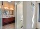 Main bathroom with double sinks and modern lighting fixtures at 10023 Uravan St, Commerce City, CO 80022