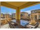 Covered patio featuring an outdoor dining table with seating and views of the surrounding neighborhood at 10023 Uravan St, Commerce City, CO 80022