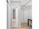 Hallway view into bathroom with tub and tiled shower at 3295 Blake St # 102, Denver, CO 80205