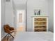 Bedroom with view to the bathroom through open door, chair, and dresser at 3295 Blake St # 102, Denver, CO 80205