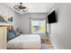 Bedroom with large window, ceiling fan, and mounted television at 3295 Blake St # 102, Denver, CO 80205