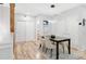 Bright dining area with modern lighting, seating for four, and wood floors at 3295 Blake St # 102, Denver, CO 80205